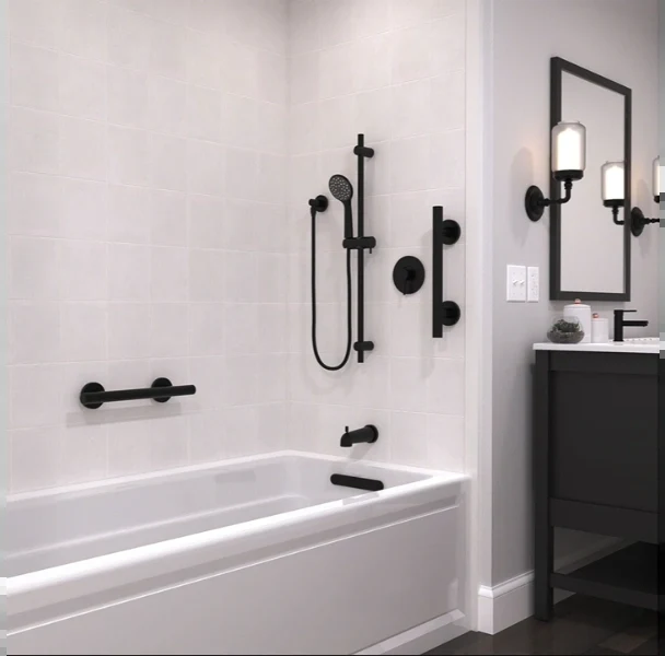 Tub and shower combination with matte black grab bars, a slide-bar handheld shower and a dark vanity